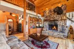 Huge Rock Fireplace in Living Room with Vaulted Ceiling